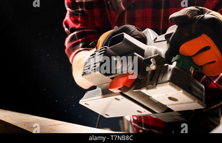 Handsome man using wood sanding machines belt sander Stock Photo