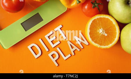 Concept diet. Healthy food, kitchen weight scale. Vegetables and fruits lettering Diet plan Stock Photo