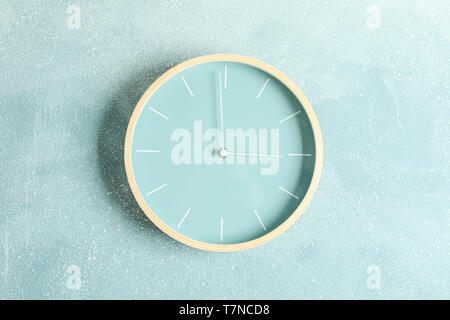 Big beautiful clock hanging on color background, space for text Stock Photo