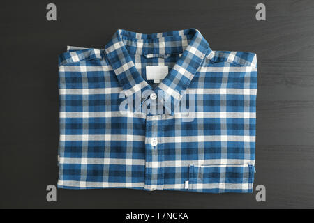 Folded checkered shirt on black table, top view Stock Photo