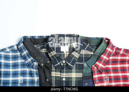 Folded colorful shirts on white background, space for text Stock Photo