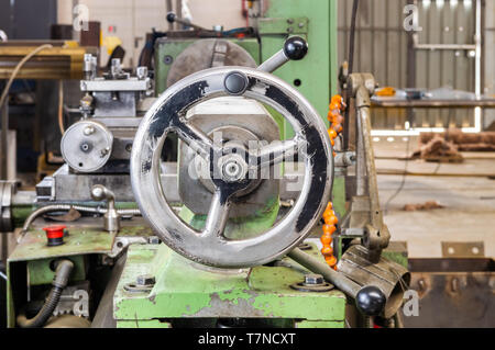 Front view of a crank wheel on industrial lathe machine in a factory. Stock Photo