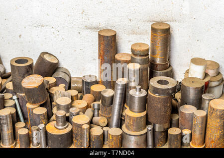Lathed steel bar stack on factory floor Stock Photo