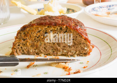 Classic American meatloaf made with ground beef oatmeal onions and a ketchup brown sugar and mustard glaze Stock Photo