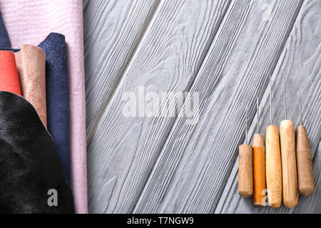 Colorful leather with craft tools on wooden background Stock Photo