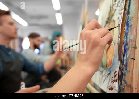 Art students painting in workshop Stock Photo