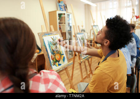 Art students painting in workshop Stock Photo