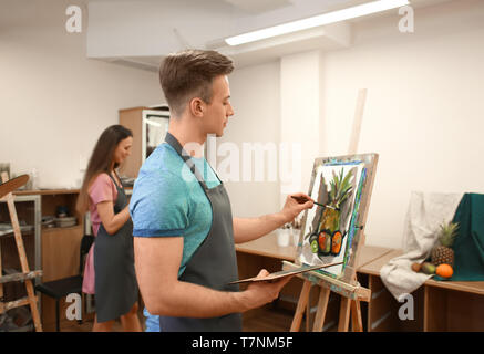 Art students painting in workshop Stock Photo
