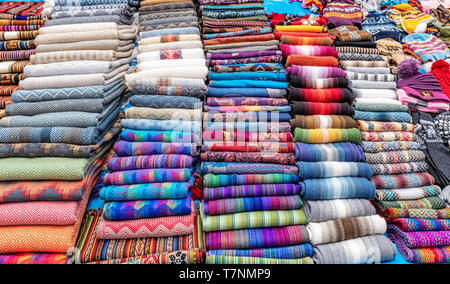 Traditional Peruvian clothes, textile handicraft and knits products made of Alpaca wool on sale on the street of small town of Chinchero in Urubamba P Stock Photo