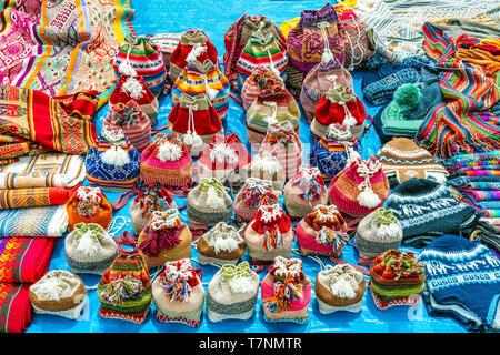 Traditional Peruvian clothes, textile handicraft and knits products made of Alpaca wool on sale on the street of small town of Chinchero in Urubamba P Stock Photo