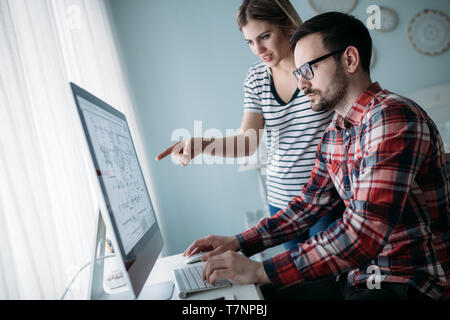 Young attractive designers working on project together Stock Photo