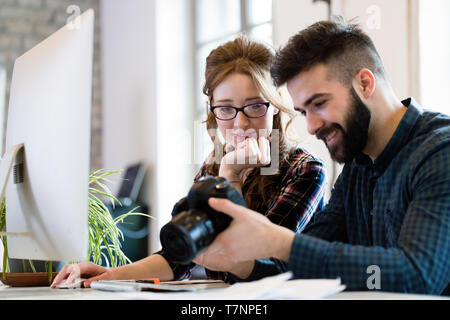 Two young designers working in modern office Stock Photo