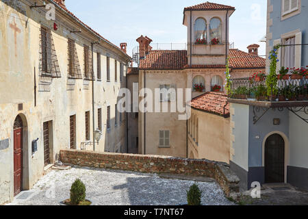 MONDOVI, ITALY - AUGUST 18, 2016: Building with little tower and balcony with flowers in a sunny summer day, blue sky in Mondovi, Italy. Stock Photo