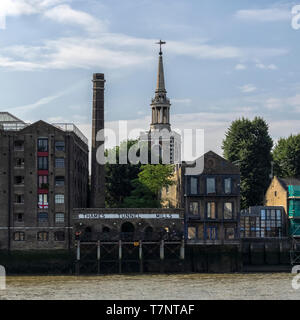 LONDON, UK - JULY 04, 2018:  The Thames Tunnel Mills Building (now apartment building) and St Mary's Church in Rotherhithe Stock Photo