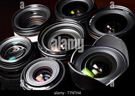 Set of various DSLR lenses with colorful reflections - shot from above Stock Photo