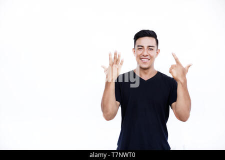 Handsome latin hispanic man is showing seven fingers isolated on white background. Place for text and design. Stock Photo