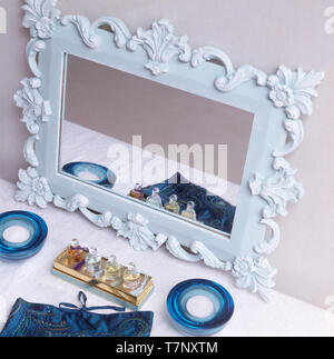 Small ornate mirror with glass tea-light holders Stock Photo