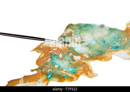 Blue, Aquan and  tan paint spilled with a small artist paint brush isolated on white Stock Photo