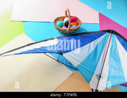 Kite with knitting yarn on color background Stock Photo