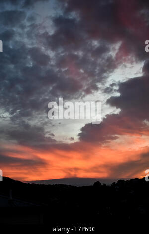 A dramatic sunrise with orange and purple colors Stock Photo