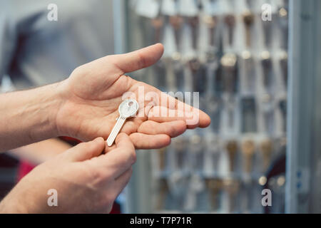 Locksmith with key blanks in his shop Stock Photo