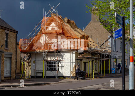 The Thatched Cottage being rethatched in Higham Ferrers, a small market town in East Northamptonshire, UK Stock Photo