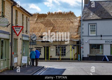The Thatched Cottage being rethatched in Higham Ferrers, a small market town in East Northamptonshire, UK Stock Photo
