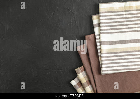 Fabric napkins on black background, space for text Stock Photo