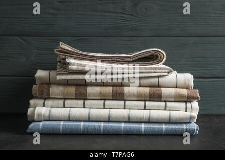Stack of fabric napkins on black table, space for text Stock Photo