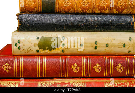Five very old antiquarian books stacked on side in leather covers isolated Stock Photo