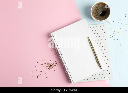 Cup of coffee with copybooks, glitter stars and pen on color background, space for text Stock Photo