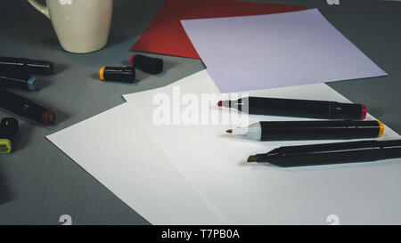 Open Colored Felt Tip Pens lie on the open notebook. Stationery for schoolchild or student Stock Photo