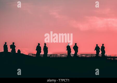 Sculptures of saints in Vatican. Silhouette on the pink sky background Stock Photo