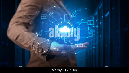 Man holding hologram projection displaying cloud technology symbols  Stock Photo