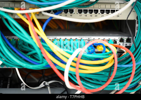 network server rack with colorful cables and ethernet switches in the data center, selected focus, narrow depth of field Stock Photo