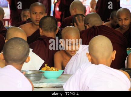 MANDALAY, MYANMAR - DECEMBER 18. 2015: Buddhist monks having breakfast at Mahagandayon Monastery Stock Photo