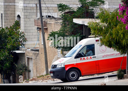 A Palestine Red Crescent Society ambulance is parked outside a hospital ...