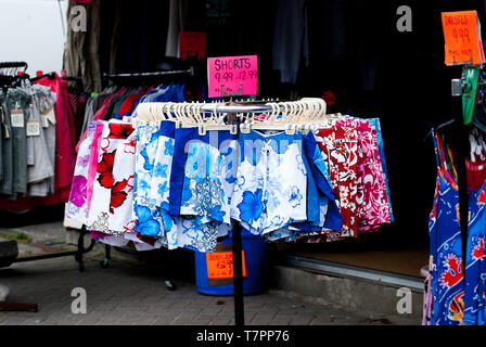 Beach shorts for sale on a stand in Perranporth, Cornwall. Stock Photo