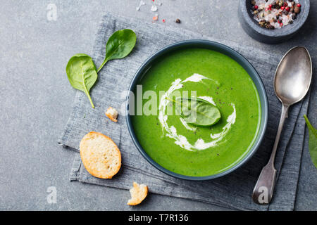 Spinach soup with cream in a bowl. Top view. Copy space. Stock Photo