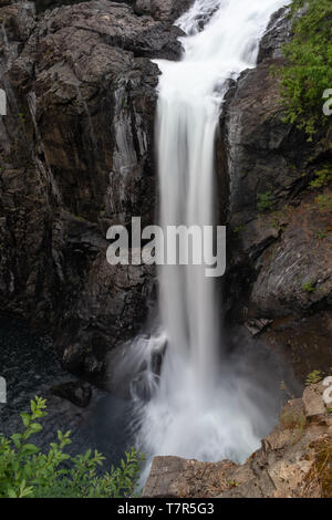 A A a large single drop waterfall cascading into the river below, long exposure shot to smooth out the cascading water Stock Photo