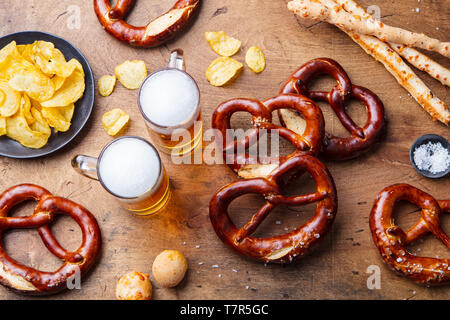 Beer, salted pretzels on wooden table background. Top view. Stock Photo