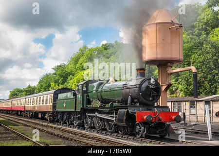 Vintage UK steam train, front view, on the railway track awaiting departure from Severn Valley Railway, Bewdley station on a sunny summer afternoon. Stock Photo