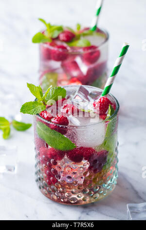 Raspberry cocktail, fizz, lemonade, ice tea with fresh mint on marble background. Close up. Stock Photo