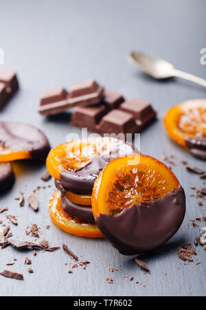 Candied orange slices in chocolate. Slate background. Copy space. Stock Photo
