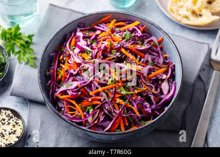 Red cabbage salad. Coleslaw in a bowl. Grey background. Close up. Stock Photo