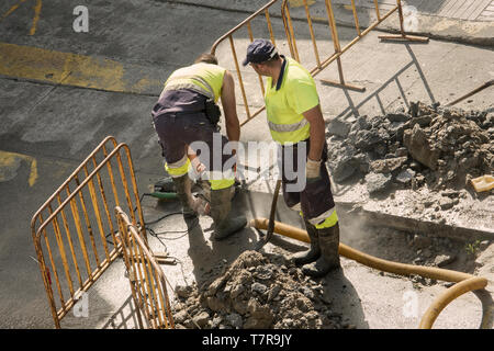 Galicia, Spain; August 02, 2018: Workers repairing a broken water pipe on the road Stock Photo