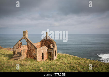 An abandoned red brick cottage on the Berwickshire coast of Scotland overlooking the North Sea. Stock Photo