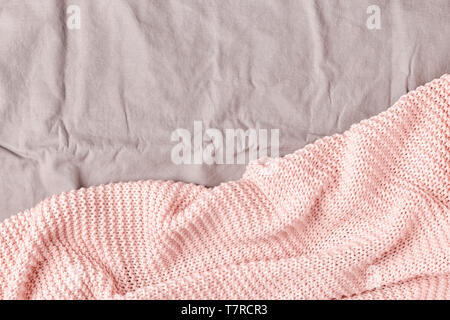 Pink plaid on the bed, top view, copy space. Stock Photo