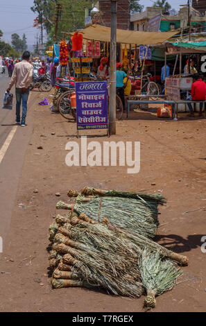 Broom heads on the side of the road for sale in the main street of Shahpura, a Dindori district town of the central Indian state of Madhya Pradesh Stock Photo