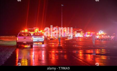 Emergency service personnel respond after a Boeing 737 aircraft skidded off the runway into the St. Johns River at Naval Air Station Jacksonville May 3, 2019 in Jacksonville, Florida. The charter aircraft was transporting 143 military passengers from Naval Station Guantanamo Bay, Cuba to Jacksonville. All passengers survived the crash. Stock Photo